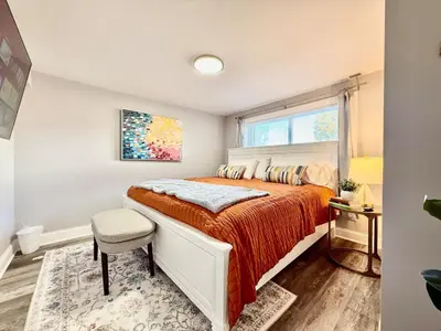 a bedroom with a large bed and a window at Cute and Cozy House in Quiet Blue Ash Neighborhood in Blue Ash