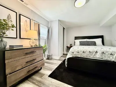 a bedroom with a bed and a dresser in it at Cute and Cozy House in Quiet Blue Ash Neighborhood in Blue Ash