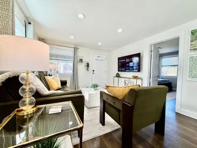 a living room with a couch and a table at Cute and Cozy House in Quiet Blue Ash Neighborhood in Blue Ash