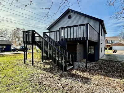 a small building with a staircase in front of it at Cute and Cozy House in Quiet Blue Ash Neighborhood in Blue Ash