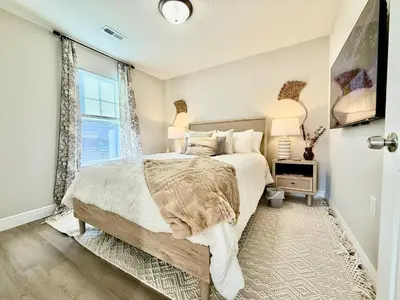 a bedroom with a large bed and a window at Cozy Equestrian Themed Getaway in Wilmington in Wilmington