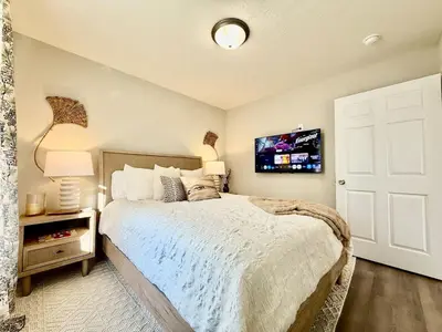a bedroom with a bed and a tv on the wall at Cozy Equestrian Themed Getaway in Wilmington in Wilmington