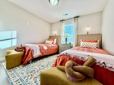 a bedroom with two beds and a chair at Cozy Equestrian Themed Getaway in Wilmington in Wilmington