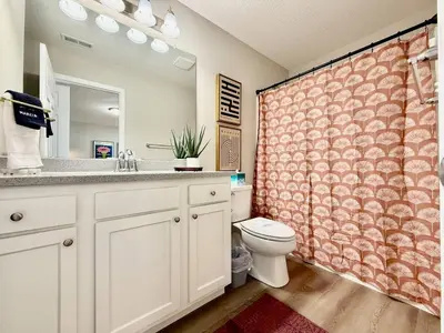 a bathroom with a toilet and a sink and a mirror at Cozy Equestrian Themed Getaway in Wilmington in Wilmington