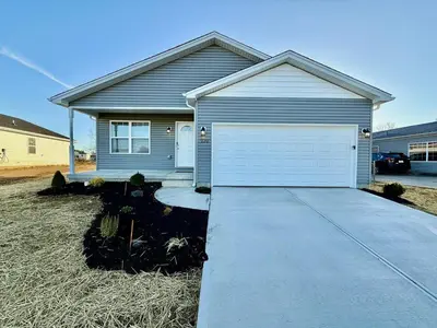 a house with a white garage in front of it at Cozy Equestrian Themed Getaway in Wilmington in Wilmington