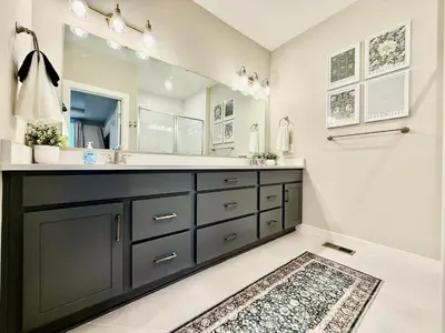 a bathroom with a sink and a large mirror at Stunning Executive Townhome Liberty Twp in Wetherington