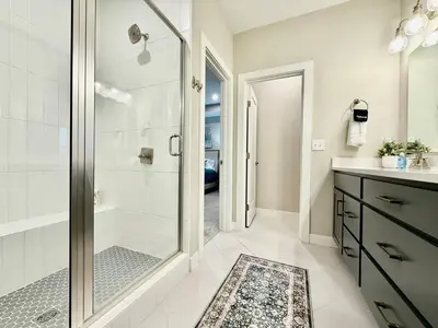 a bathroom with a walk in shower and a glass shower stall at Stunning Executive Townhome Liberty Twp in Wetherington