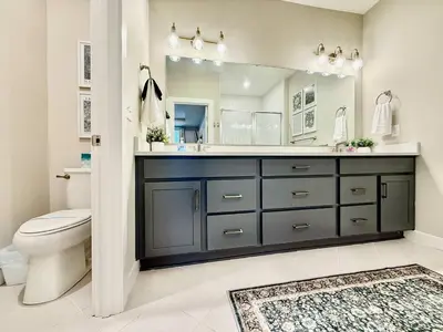 a bathroom with a sink and a toilet and a mirror at Stunning Executive Townhome Liberty Twp in Wetherington