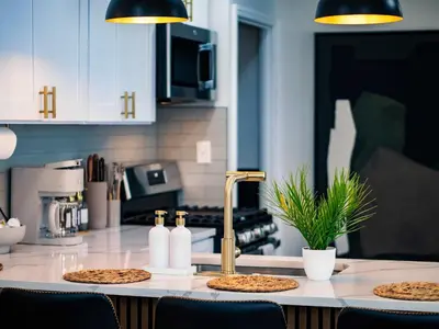a kitchen with a counter with two pizzas on it at Comfortable 3BR home with workspace & parking in Parma
