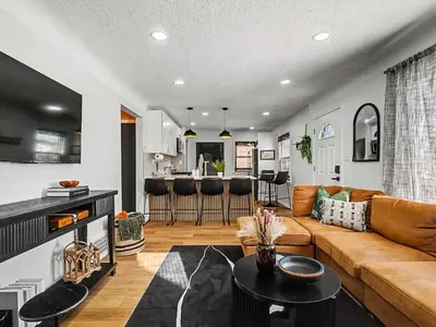 a living room with a couch and a table at Comfortable 3BR home with workspace & parking in Parma