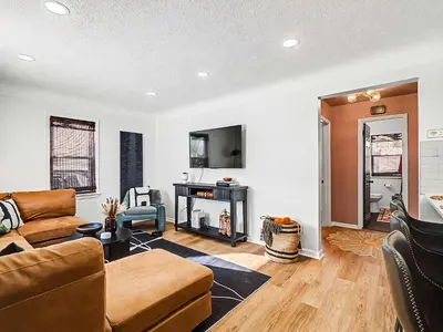 a living room with a couch and a fireplace at Comfortable 3BR home with workspace & parking in Parma