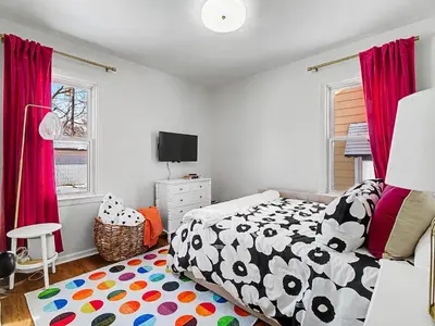 a bedroom with a bed with a black and white comforter at Comfortable 3BR home with workspace & parking in Parma