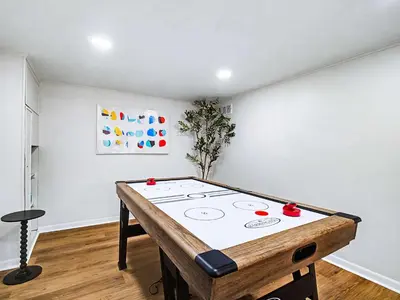 a ping pong table in a room at Comfortable 3BR home with workspace & parking in Parma