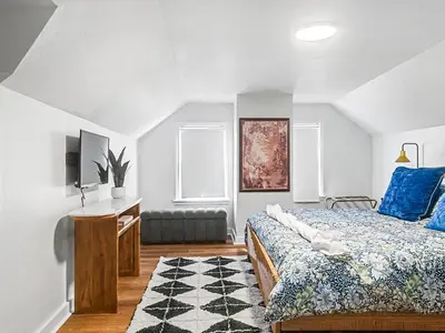 a bedroom with a bed and a desk and a window at Comfortable 3BR home with workspace & parking in Parma