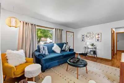 a living room with a blue couch and a yellow chair at Akron in Akron