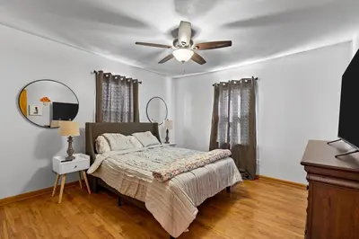 a bedroom with a bed and a ceiling fan at Akron in Akron