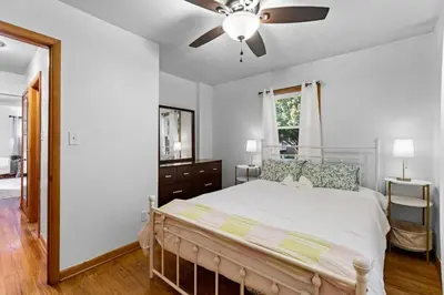 a bedroom with a bed and a ceiling fan at Akron in Akron