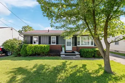 a house with a tree in a yard at Akron in Akron