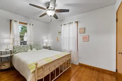 a bedroom with a bed and a ceiling fan at Akron in Akron