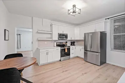a kitchen with white cabinets and stainless steel appliances at Rivers Edge Retreat For 10ppl in Dayton