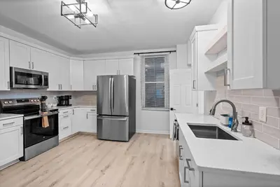 a kitchen with white cabinets and a stainless steel refrigerator at Rivers Edge Retreat For 10ppl in Dayton