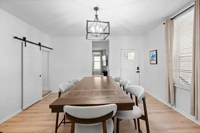 a dining room with a wooden table and chairs at Rivers Edge Retreat For 10ppl in Dayton