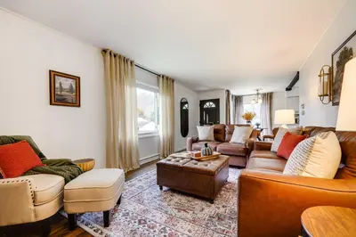 a living room with a couch and a table at Serenity on Sanford in Portsmouth
