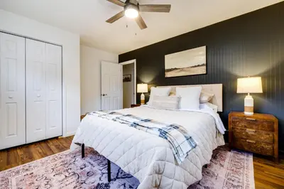 a bedroom with a bed and a ceiling fan at Serenity on Sanford in Portsmouth
