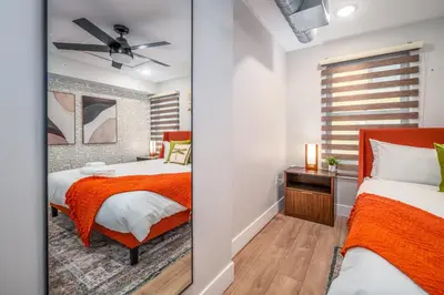 a bedroom with two beds and a window at OTR 1BR by TQL, Sleeps 4ppl, Lux King Bed, Wifi, 4th Fl in Cincinnati