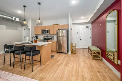 a kitchen with a counter and chairs in a room at OTR 1BR by TQL, Sleeps 4ppl, Lux King Bed, Wifi, 4th Fl in Cincinnati