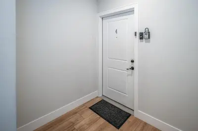 a door leading into a room with a rug at OTR 1BR by TQL, Sleeps 4ppl, Lux King Bed, Wifi, 4th Fl in Cincinnati