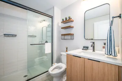 a bathroom with a toilet and a sink and a shower at OTR 1BR by TQL, Sleeps 4ppl, Lux King Bed, Wifi, 4th Fl in Cincinnati