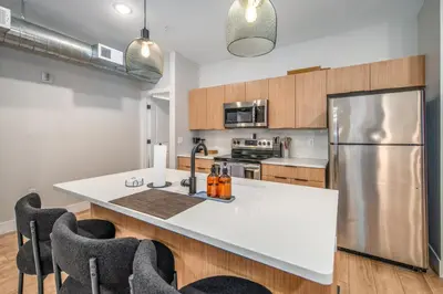 a kitchen with a white counter top and a refrigerator at OTR 1BR by TQL, Sleeps 4ppl, Lux King Bed, Wifi, 4th Fl in Cincinnati