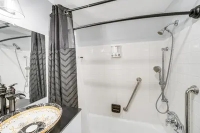a bathroom with a sink and a shower at 6 Mi to Downtown Cleveland Lakeview Condo! in Lakewood