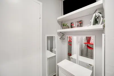 a bathroom with white cabinets and a mirror at 6 Mi to Downtown Cleveland Lakeview Condo! in Lakewood