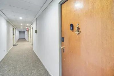 an office hallway with a door and a hallway sidx sidx at 6 Mi to Downtown Cleveland Lakeview Condo! in Lakewood