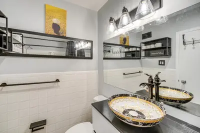 a bathroom with two sinks and a toilet at 6 Mi to Downtown Cleveland Lakeview Condo! in Lakewood