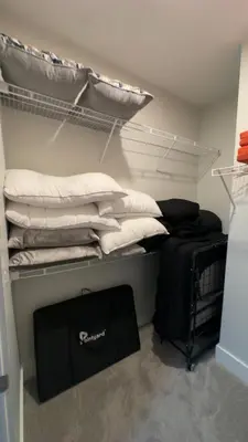 a room with a bunk bed with a pile of pillows at The 513 Flat 2! 1BR, 1Bath Apt with Pool and Riverfront View! Free Gated Parking! Only Steps from The banks & Stadiums! in Cincinnati