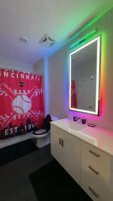 a bathroom with a large mirror and a sink at The 513 Flat 2! 1BR, 1Bath Apt with Pool and Riverfront View! Free Gated Parking! Only Steps from The banks & Stadiums! in Cincinnati