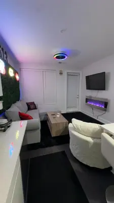 a living room with a white couch and a tv at The 513 Flat 2! 1BR, 1Bath Apt with Pool and Riverfront View! Free Gated Parking! Only Steps from The banks & Stadiums! in Cincinnati
