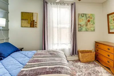 a bedroom with a bed and a window and a dresser at Close to Camden Clark Central Parkersburg Condo in Parkersburg