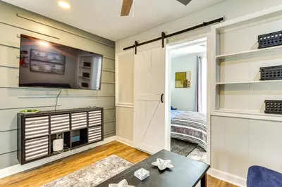 a living room with a door leading to a bedroom at Close to Camden Clark Central Parkersburg Condo in Parkersburg