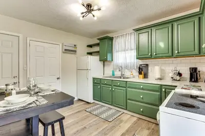 a kitchen with green cabinets and a white refrigerator at Close to Camden Clark Central Parkersburg Condo in Parkersburg