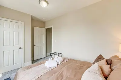 a bedroom with a large bed with white walls at Quiet & Spacious Home Near Downtown in Columbus