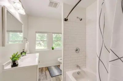 a white bathroom with a tub and a sink at Quiet & Spacious Home Near Downtown in Columbus