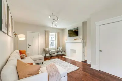 a living room with a white couch and a fireplace at Quiet & Spacious Home Near Downtown in Columbus