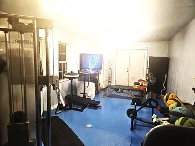 a room with a gym with machines and a television at Secluded one room house on 235 acres in Salem