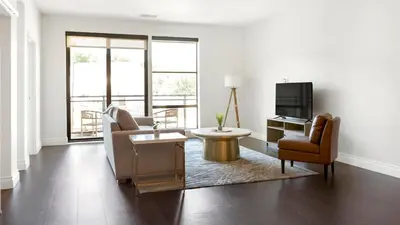 a living room with a couch and chairs and a television at Landing Spectacular 2BD Gym in Cleveland