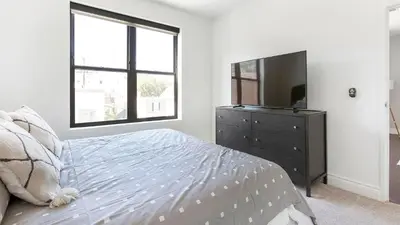 a bedroom with a bed and a tv on a dresser at Landing Spectacular 2BD Gym in Cleveland