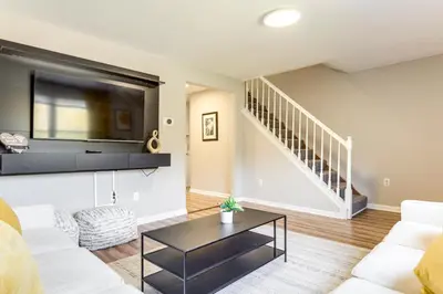 a living room with a couch and a tv at 6 Mi to Downtown Cincy Group-Friendly Townhome! in Cincinnati